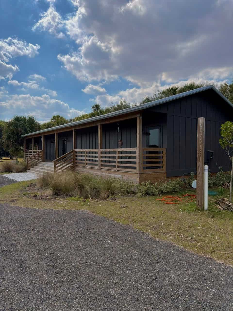 Finished barndominium with wraparound porch built by GRV Construction