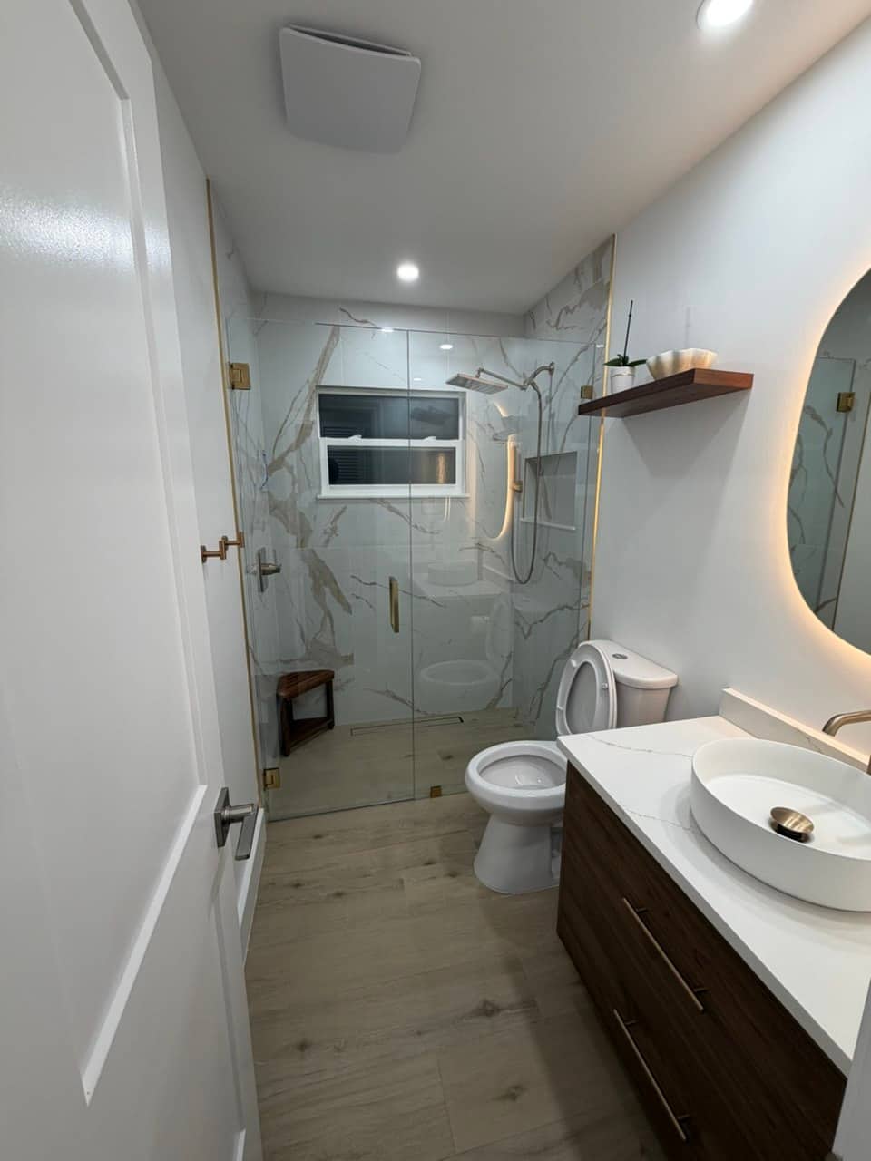Finished GRV bathroom remodel — marble-look tile shower and floating vanity
