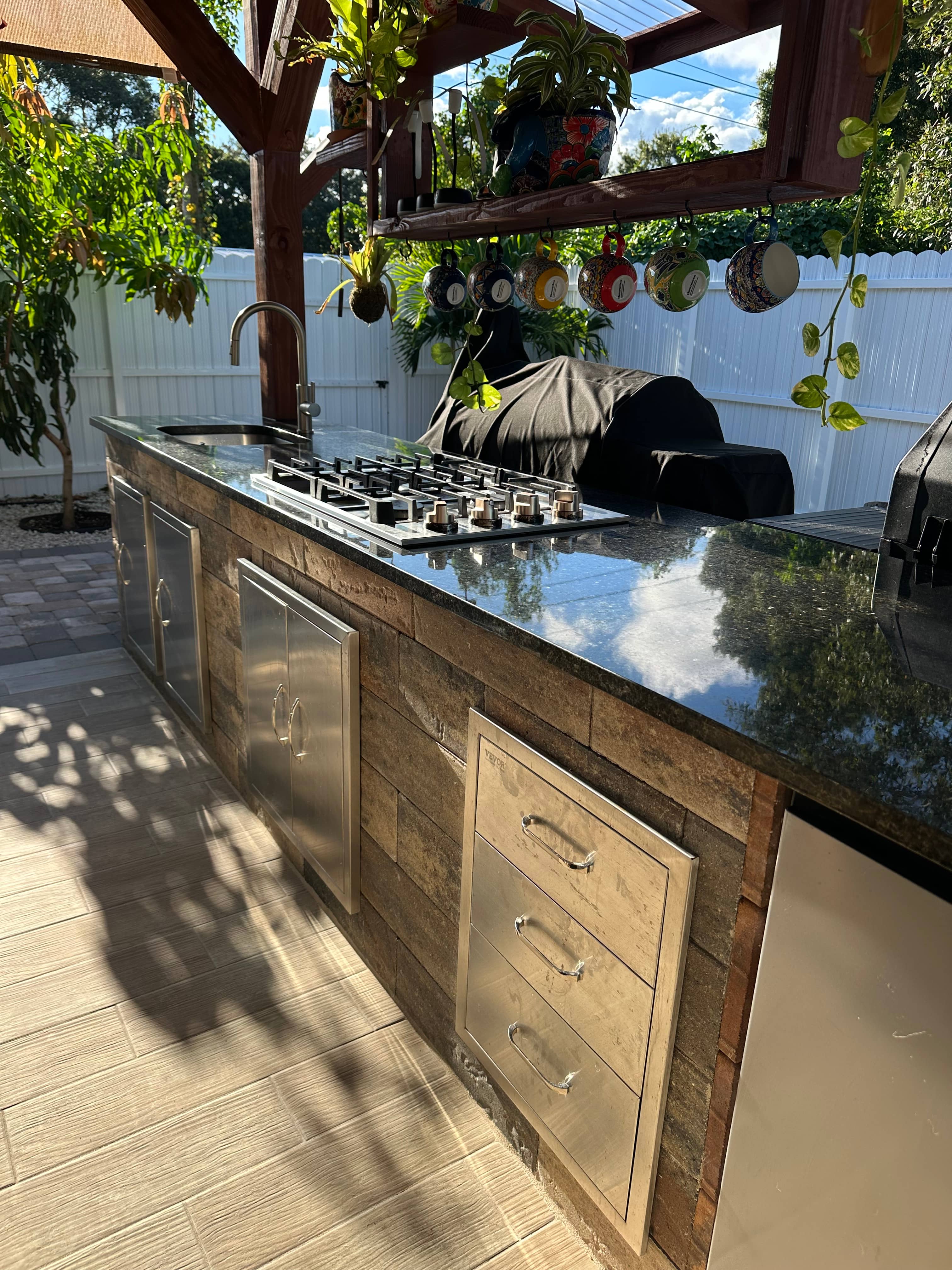 Finished GRV outdoor kitchen build in Vero Beach — stone-clad island with granite top